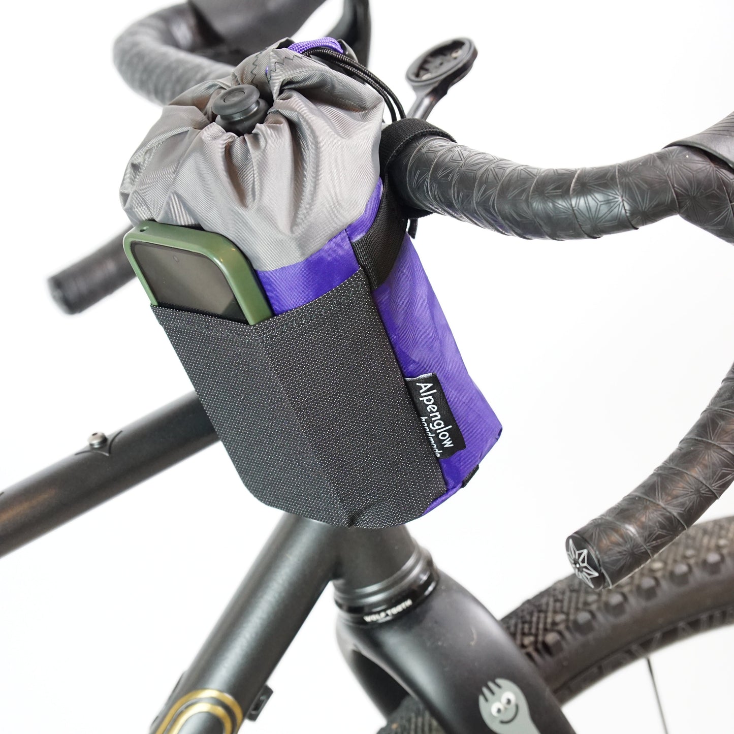Bicycle handlebar bag attached to a bike frame with visible brand logo.