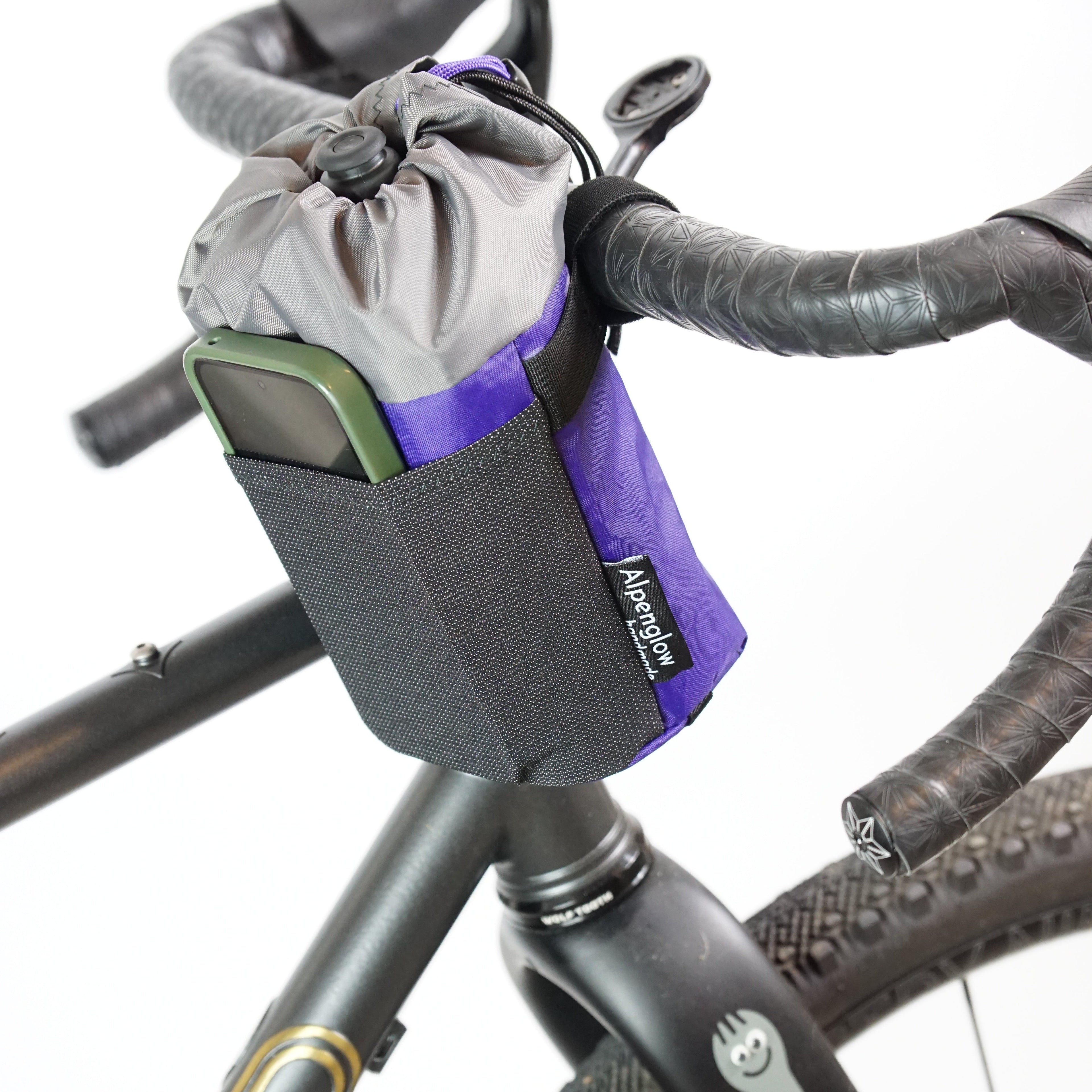 Bicycle handlebar bag attached to a bike frame with visible brand logo.