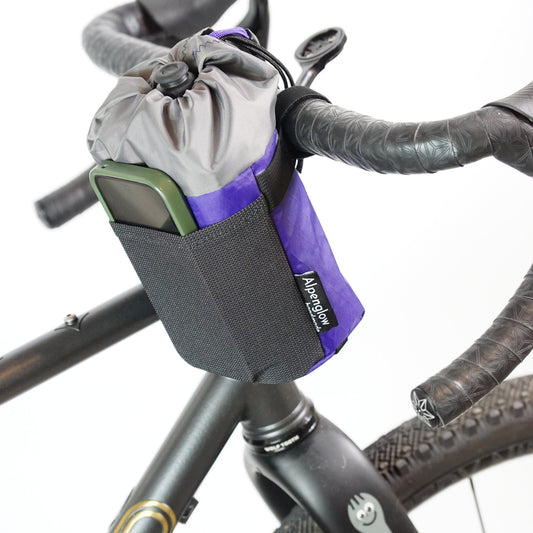 Bicycle handlebar bag attached to a bike frame with visible brand logo.
